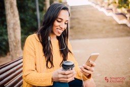 asian-girl-holding-coffee-phone