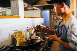 asian-chef-frying-rice-in-kitchen